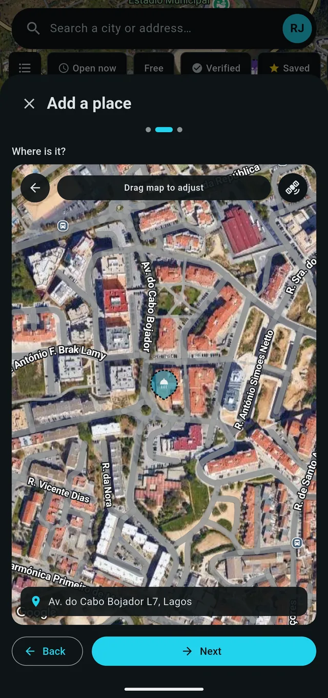 The add-place location step, with the pin fixed in the centre of a satellite map and a looked-up address shown on a card below it.